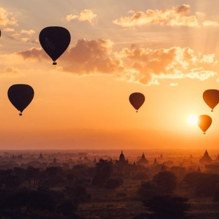 Hot-air balloons float in the sky during a stunning sunset above the ancient city of Bagan in Myanmar. Photo: Joel Sparks/Unsplash