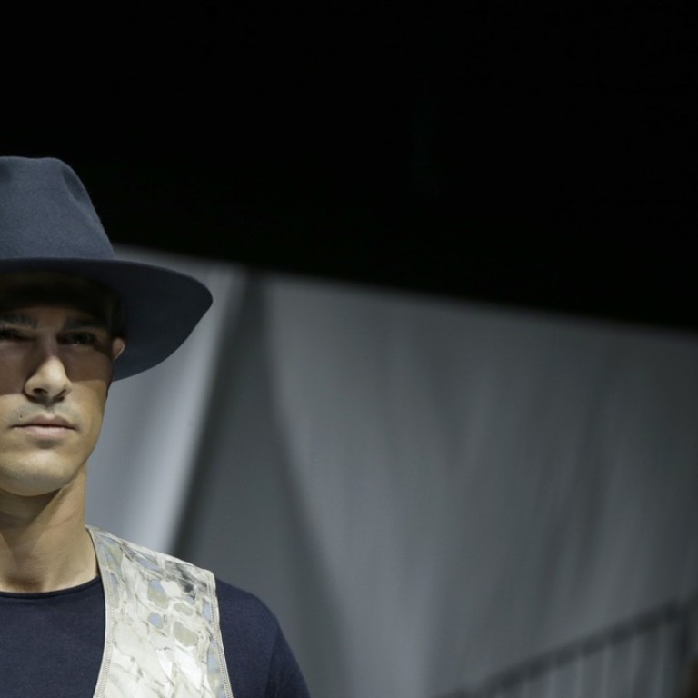 A model wears a creation as part of the Armani men's 2019 spring-summer collection, during Fashion Week in Milan, Italy on Monday, June 18. (AP Photo/Luca Bruno)