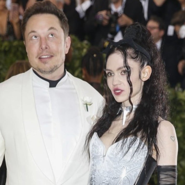 Elon Musk (left) co-founder and CEO of the electric vehicle maker Tesla – pictured with artist Grimes – says he is looking for video game developers to create games that will integrate his cars and touch screens with phones. Photo: Reuters