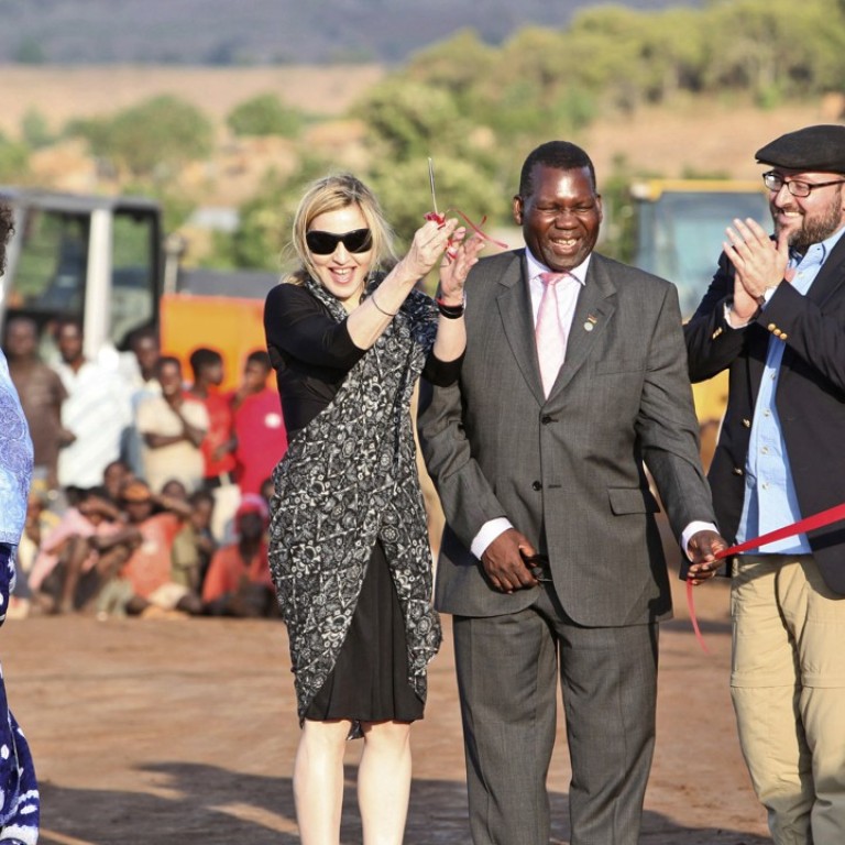 American singer Madonna (second left) set up the charity Raising Malawi in 2006 to make learning and schools accessible to children – particularly girls – in the African nation of Malawi. Photo: AP