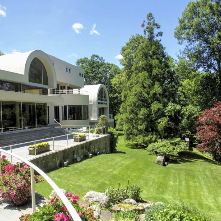 The mansion is constructed over three levels and has terraces overlooking Mallard Lake.