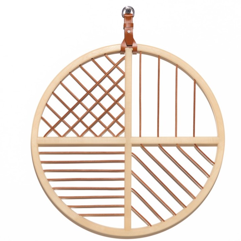 Hermès. The Attrape-rêves with a natural solid maple frame and vicuna leather cord can be used for hanging scarves, ties or photographs. Price on request