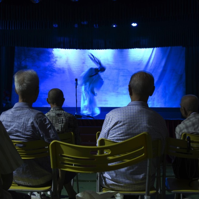 Residents watch an opera performance at a makeshift theatre during the Hungry Ghost Festival in Hong Kong. Photo: AP