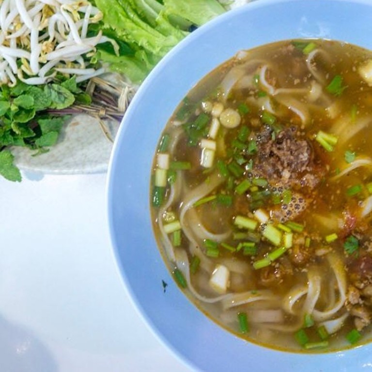 Khao soi is a pork mince and rice noodle dish in a hearty soup, served with an abundance of vegetables. Photo: Instagram @laughtraveleatsalot