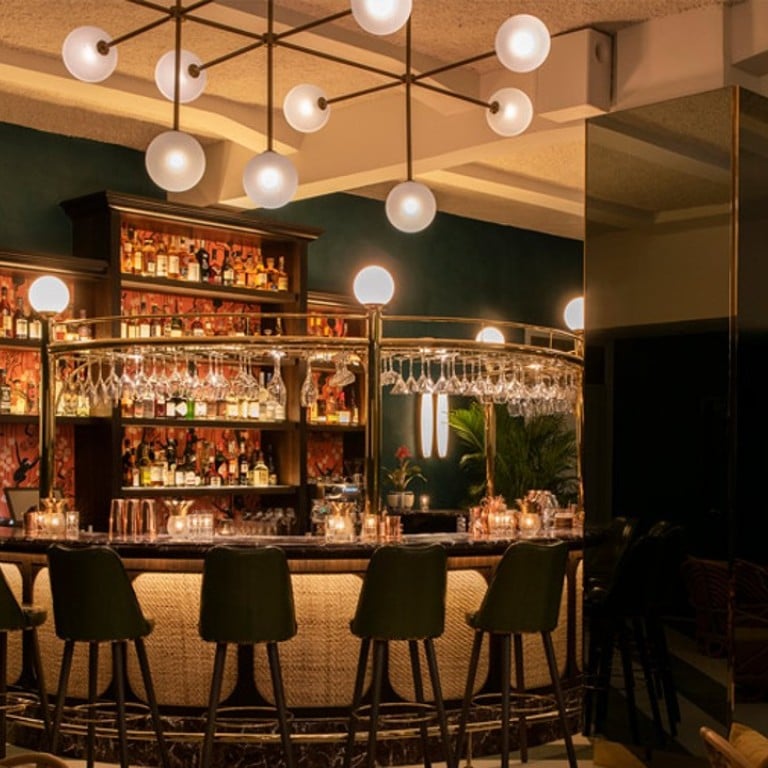 The bar at Straits Clan private club in Singapore, which stocks many rare whiskies and wines, features rattan furniture and onyx accents. Photos: Straits Clan