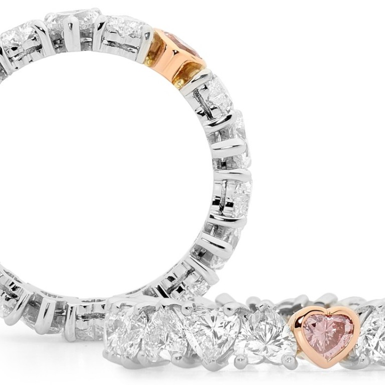 Rohan Jewellery Hearts ring with a heart shape Argyle pink diamond set among a band of white diamond hearts. Photo: Conrad VANECEK