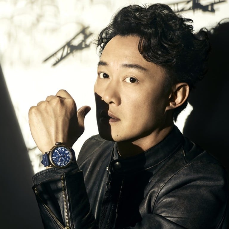 Eason Chan wearing Zenith’s PilotType 20 Extra Special Chronograph in bronze with blue dial.