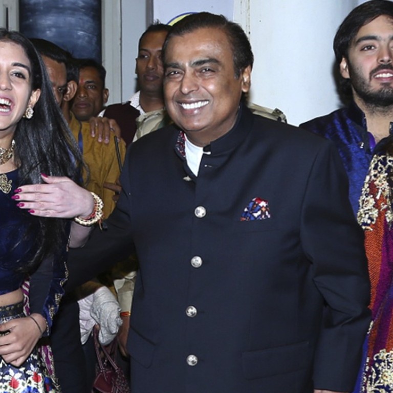 Mukesh Ambani, chairman of Reliance Industries (centre) and his wife Nita Ambani (back, far left), held lavish pre-wedding rituals last weekend ahead of the marriage of their daughter Isha Ambani (right) to Anand Piramal, the son of Indian industrialist Ajay Piramal, in Udaipur, India, on Tuesday. Photo: AP
