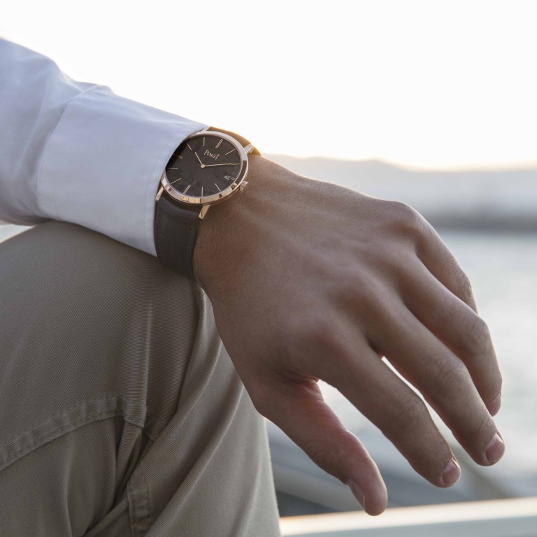 A model wears the Piaget Altiplano with a grey meteorite dial.