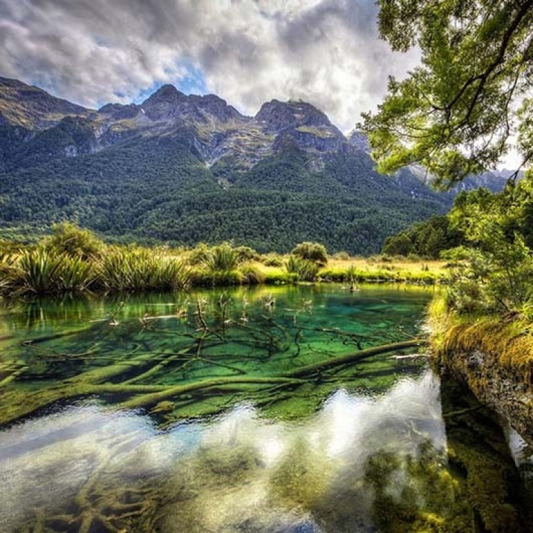 A lake on the way to Milford Sound. New Zealand Walking Tours takes you through paths seldom trodden to locations not accessible by land vehicles.