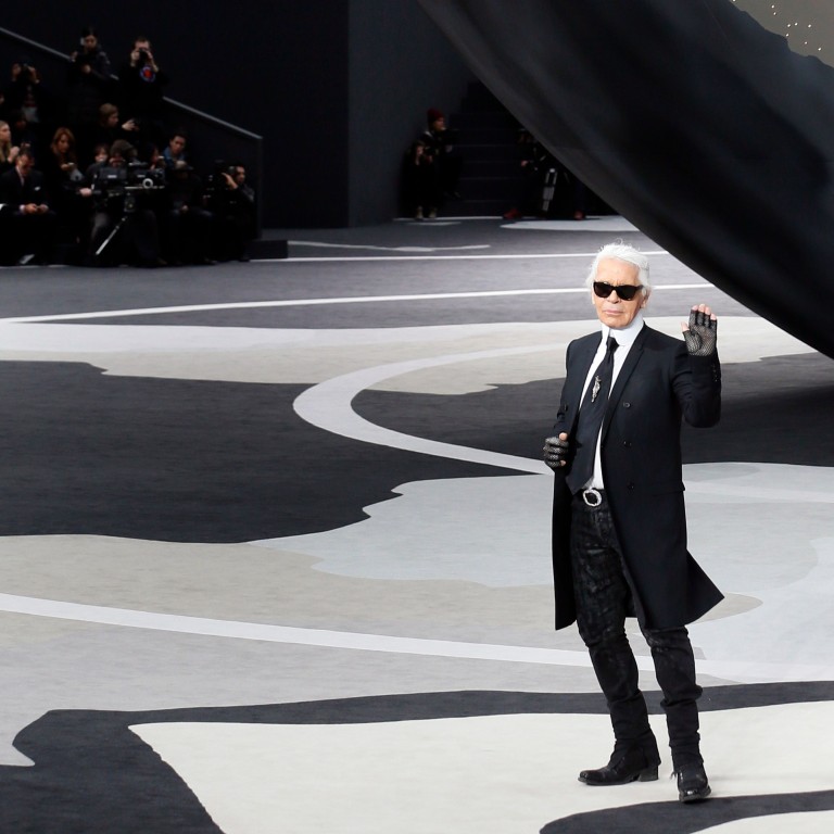 In this photo taken on March 5, 2013, German fashion designer Karl Lagerfeld for Chanel acknowledges the public during the fall/winter 2013/2014 ready-to-wear collection show at the Grand Palais in Paris. Photo: Patrick Kovarik / AFP