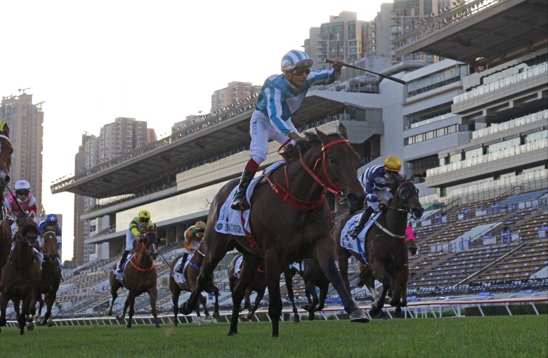 Karis Teetan celebrates as he crosses the line on Romantic Warrior to win the Classic Mile. Photos: HKJC