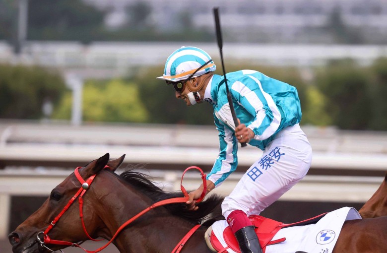 Karis Teetan celebrates winning the BMW Hong Kong Derby aboard Romantic Warrior. Photo: HKJC
