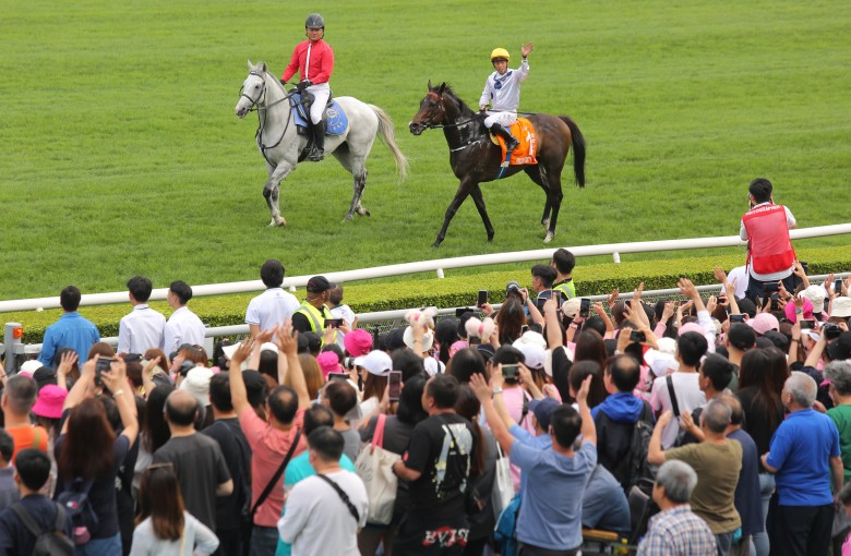 Jockey Vincent Ho waves to the crowd after Golden Sixty’s Champions Mile victory at Sha Tin on Sunday. Photo: Kenneth Chan