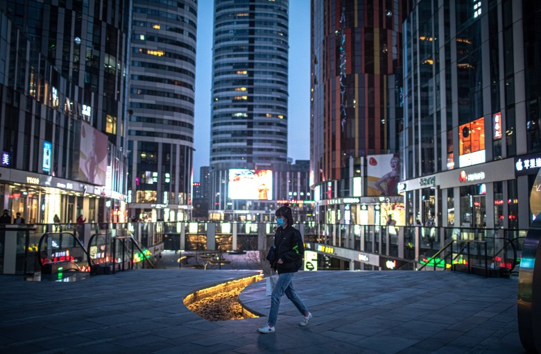 A woman walks in the nearly deserted shopping area of Sanlitun in Beijing in 2020. Photo: EPA-EFE