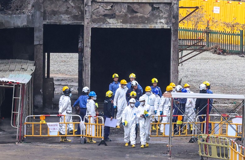 Members of the independent investigation committee of the Wang Fuk Court fire, wearing protective suits, inspect the fire scene on December 23. Photo: Jelly Tse