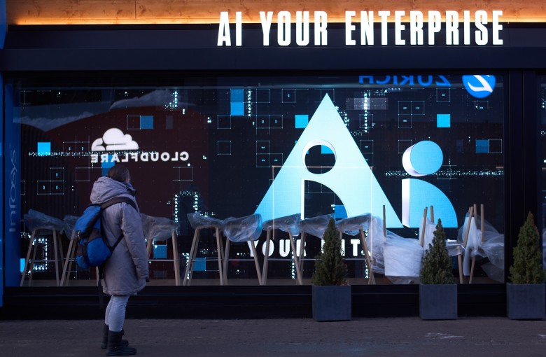 A woman looks at the window of a company advertising AI ahead of the annual meeting of the World Economy Forum in Davos, Switzerland, on January 17. Photo: AP