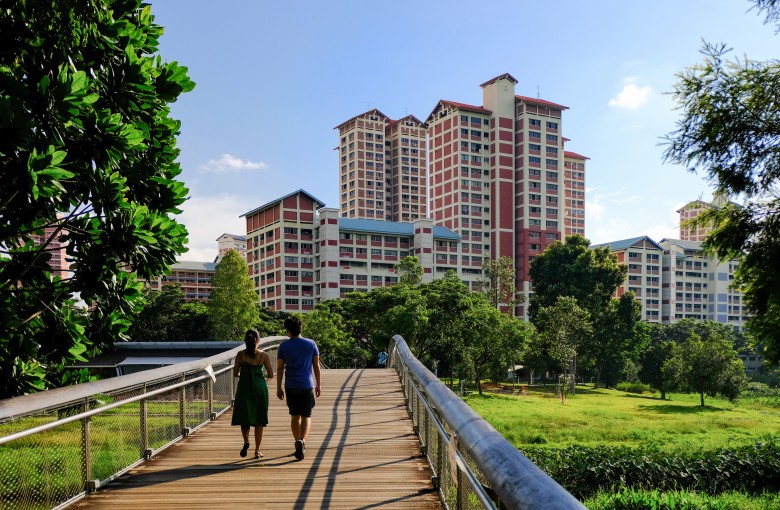 People walk through a park in Singapore, with high-rise public housing in the background. Photo: Shutterstock