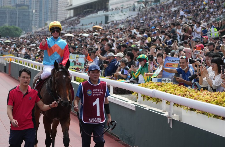 Jockey Zac Purton celebrates with horse racing enthusiasts after the victory of Ka Ying Rising at Sha Tin. Photo: Sam Tsang