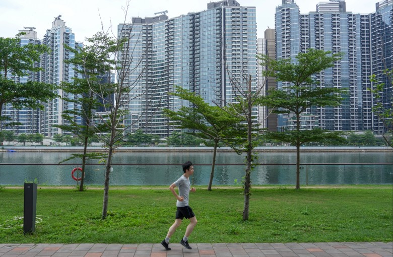 A runner jogs down a path near blocks of flats in Kai Tak on May 3. Photo: Sam Tsang