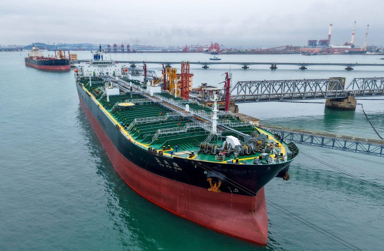 An oil tanker unloads imported crude at Qingdao port, in Chinas eastern Shandong province, on July 16. Photo CN-STR / AFP