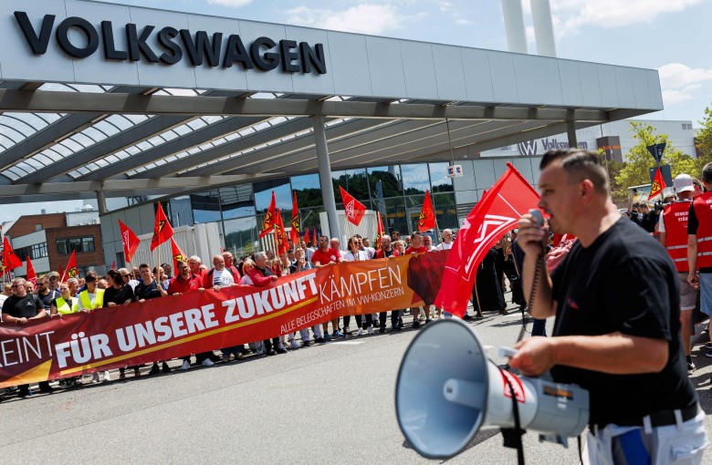 A participant addresses employees of German car maker Volkswagen during a rally by German trade union IG Metall to protest against restructuring and mass job cut plans, at the VW plant in Zwickau, eastern Germany, on July 9. Photo: AFP
