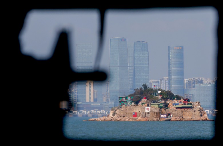 A mannequin points a model gun from inside a bunker past Shihyu, towards the skyline of Xiamen, a coastal city in mainland China, in Lieyu, Kinmen, Taiwan, in 2021. Photo: Reuters