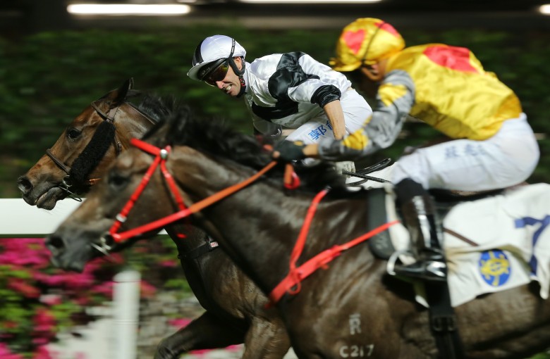 Neil Callan lifts Jolly Convergence to victory at Happy Valley on Wednesday night. Photos: Kenneth Chan