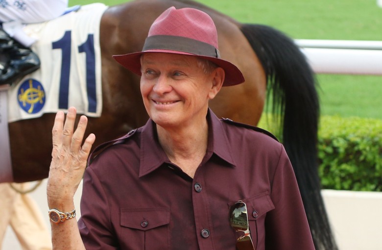 Resplendent in a purple safari suit, John Moore celebrates his four-timer. Photos: Kenneth Chan