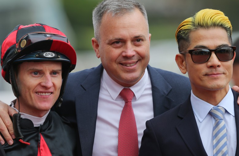 Trainer Caspar Fownes (middle) celebrates the win of Dancing Fighter with jockey Zac Purton (left) and Canto-pop superstar Aaron Kwok (right). Photos: Kenneth Chan