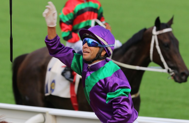 Joao Moreira celebrates his opening-day win aboard Excellent Proposal with his customary whip throw. Photos: Kenneth Chan