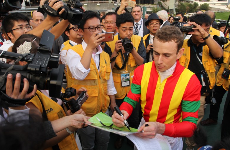 Ryan Moore surrounded by press after winning the 2016 Hong Kong Cup aboard Maurice. Photos: Kenneth Chan