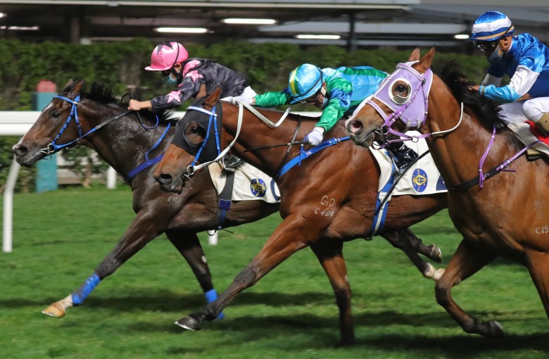Keith Yeung drives The Anomaly (left) to victory at Happy Valley on Wednesday night. Photo: Kenneth Chan