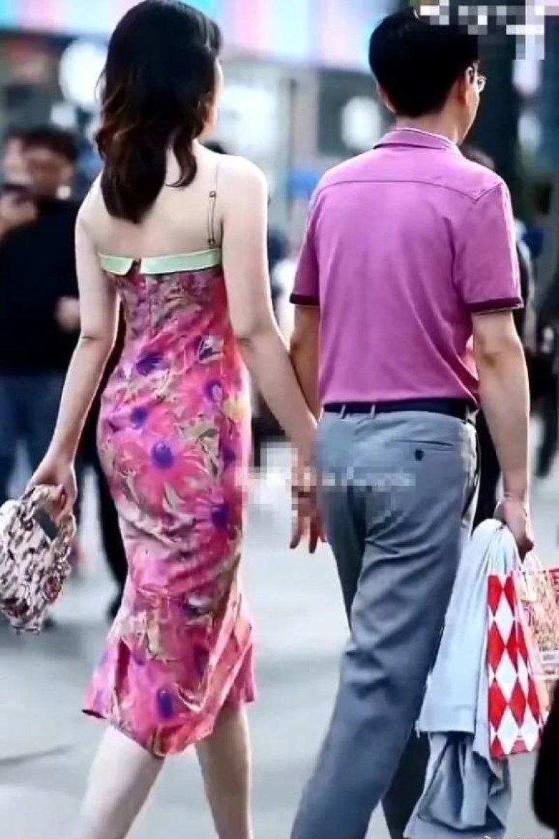 A Chinese woman wearing a Louis Vuitton dress and carrying a