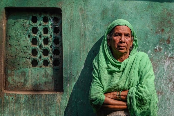 Sultana Begun poses for a photo near the cramped two-room hut where she lives in Kolkata. Photo: AFP