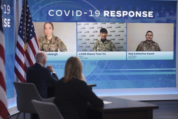 US President Joe Biden (left) speaks on his administration’s Covid-19 surge response as members of the military from Arizona, New York and Michigan listen on a screen in Washington on Thursday. Photo: Bloomberg