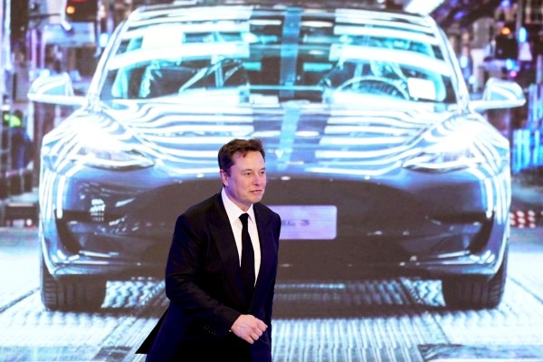Tesla CEO Elon Musk walks next to a screen showing an image of Tesla Model 3 car. A new study found that Tesla Autopilot and other driver assisted systems underperform. Photo: Reuters