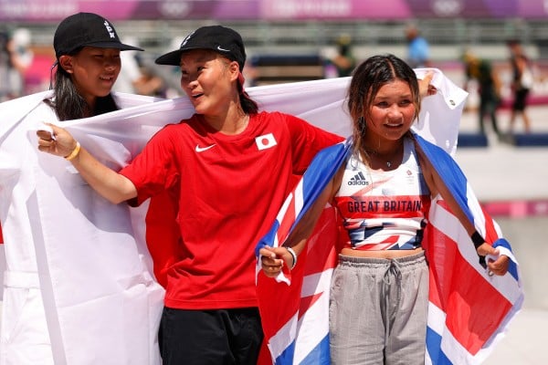 Great Britain’s Sky Brown with Sakura Yosozumi and Kokona Hiraki, of Japan, after the women’s skateboarding park finals at the Tokyo 2020 Olympic Games at the Ariake Urban Sports Park. Photo: Getty Images Great Britain’s Sky Brown with Sakura Yosozumi and Kokona Hiraki, of Japan, after the women’s skateboarding park finals at the Tokyo 2020 Olympic Games at the Ariake Urban Sports Park. Photo: Getty Images
