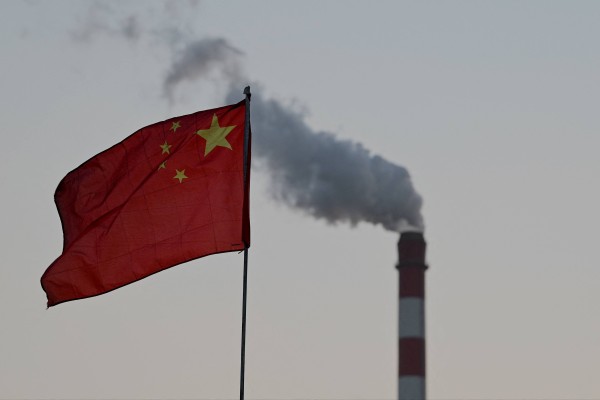 China’s national flag flutters in front of a coal-powered power station in Datong, northern Shanxi province. Photo: AFP
