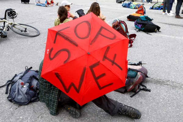 A protester holds up an umbrella during a protest against the World Economic Forum meeting, which has now ended. Reuters