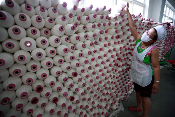 A near doubling in benchmark cotton futures to 11-year highs, hard on the heels of a spike in freight and fuel prices, is clobbering Asian apparel makers while their global retail customers are reluctant to soak up the extra costs. Photo: AFP