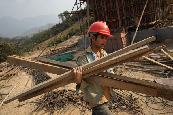A Chinese worker in Luang Prabang carries materials for the China-Laos Railway, a key belt and road project that opened in December. Photo: AFP