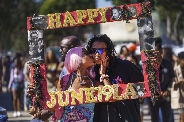 Daisa Chantel kisses Anthony Beltran as they celebrate “Juneteenth” 2022 in Los Angeles, US. Photo: AP