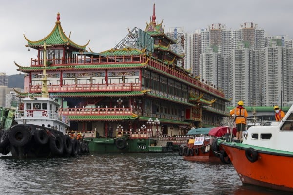 Tugboats begin the final journey of the Jumbo Floating Restaurant from Hong Kong’s Aberdeen Harbour to its ignominious grave at the bottom of the South China Sea. Photo: Dickson Lee Tugboats begin the final journey of the Jumbo Floating Restaurant from Hong Kong’s Aberdeen Harbour to its ignominious grave at the bottom of the South China Sea. Photo: Dickson Lee