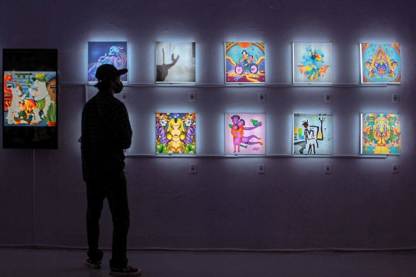A visitor observes NFT works at an exhibition in Yogyakarta, Indonesia. Photo: AFP