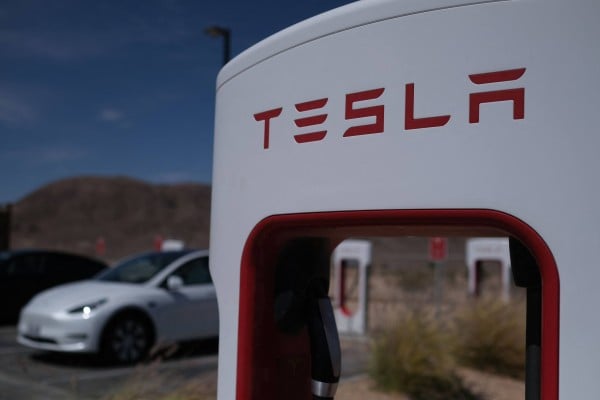 Tesla cars sit at charging stations in Yermo, California. Photo: AFP Tesla cars sit at charging stations in Yermo, California. Photo: AFP
