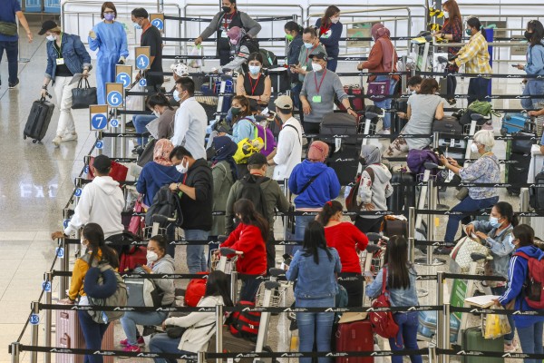 Arrivals at Hong Kong’s airport. The city has one of the toughest quarantine systems in the world. Photo: K. Y. Cheng