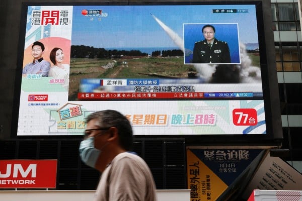 A report on China’s People’s Liberation Army’s military exercises near Taiwan is displayed on a screen in Hong Kong on Friday. Photo: Reuters