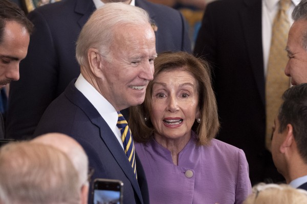 US President Joe Biden stands with House Speaker Nancy Pelosi during a ceremony at the White House on Wednesday. Photo: EPA-EFE