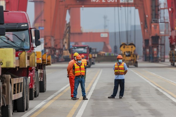 Workers wait at a port in China’s Jiangsu province. Shipping agents across the country are reporting plummeting demand for exports. Photo: EPA-EFE